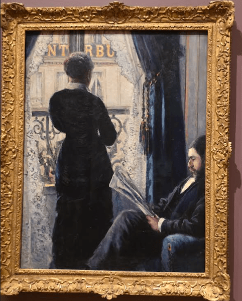 A framed painting depicting a man sitting and reading a newspaper in a chair while a woman stands by a window looking outside, with a lush curtain visible in the foreground.