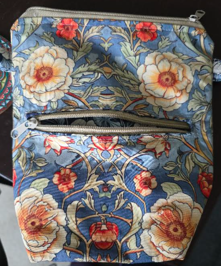 Blue floral fabric pouch with two zippered compartments